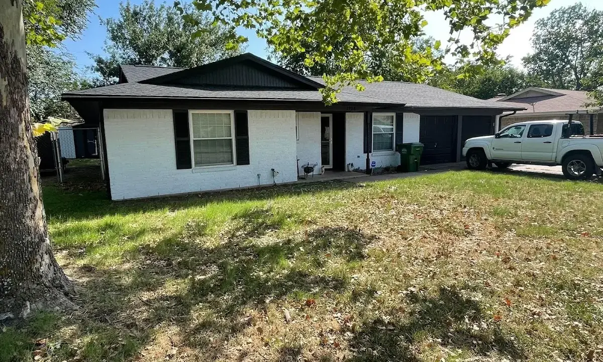 Professional roofing crew working on a residential roof in Notre Dame